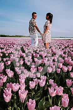Tulip fields in the Netherlands, couple men and woman in flower field during Spring in the Nethertlands