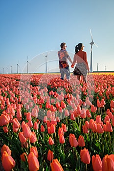 Tulip fields in the Netherlands, couple men and woman in flower field during Spring in the Nethertlands