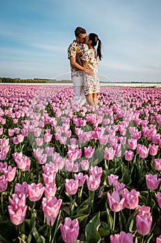 Tulip fields in the Netherlands, couple men and woman in flower field during Spring in the Nethertlands