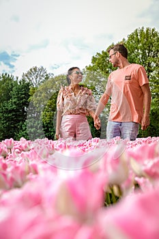 Tulip fields in the Netherlands, couple men and woman in flower field during Spring in the Nethertlands