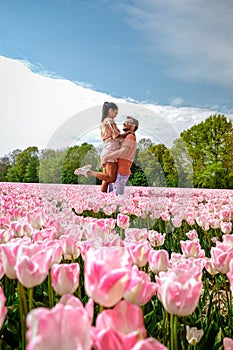 Tulip fields in the Netherlands, couple men and woman in flower field during Spring in the Nethertlands