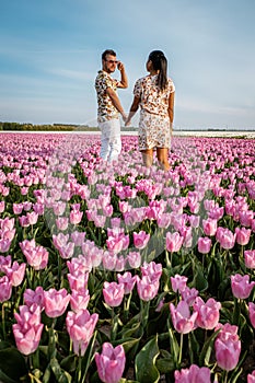 Tulip fields in the Netherlands, couple men and woman in flower field during Spring in the Nethertlands