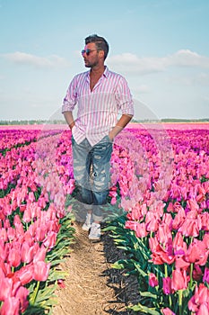 Tulip fields in the Netherlands, men in flower field during Spring in the Nethertlands