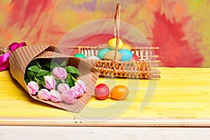 Tulip flower bouquet. Healthy and happy holiday. painted eggs in egg basket. Happy easter. Egg hunt. Spring holiday