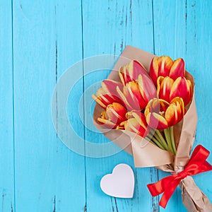 Tulip flower bunch, Mother`s Day Design Concept - Beautiful Red, yellow bouquet  on blue wooden background, top view, fla