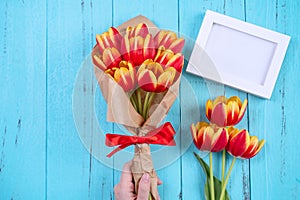 Tulip flower bunch, photo frame, Mother`s Day Concept - Beautiful Red, yellow bouquet, white blank picture template  on