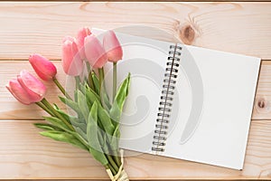 Tulip flower with white blank note book page background on white wood backdrop for motherÃ¢â¬â¢s day holiday card