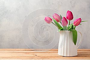 Tulip flowers bouquet on wooden table. Mothers day celebration