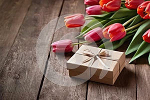 tulip flowers and gift box on wooden table