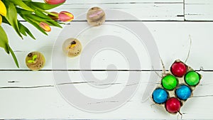 Tulips, bunnies and eggs on wooden background