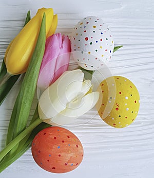 Tulips easter eggs on white wooden