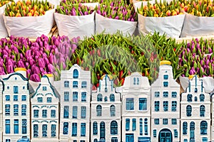 Tulips in a flower shop with souvenir Amsterdam canal houses in