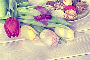 Tulips and homemade chocolate candys wooden background