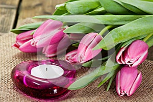 Tulips on old brown wooden table with a Stickies