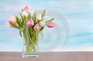 Tulips on pastel blue watercolor background