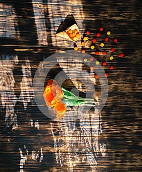 Tulips with sweets in a waffle horn on a wooden background