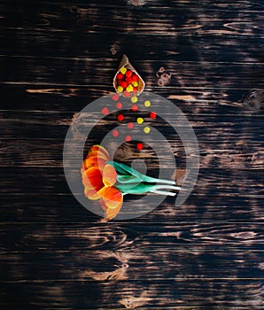 Tulips with sweets in a waffle horn on a wooden background