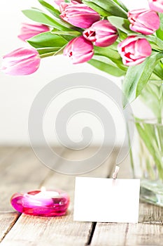 Tulips in vase and candle