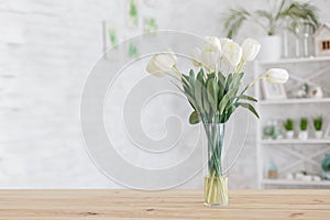 Tulips in a vase on a wooden table. Scandinavian interior