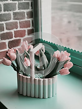 Tulips on the windowsill. Flowers in a decorative pot. Coffee shop interior
