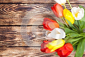 Tulips on wooden background with ribbon