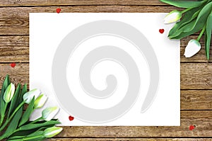 Tulips on wooden background with space for message. Mother`s Day background. Flowers on rustic table for March 8