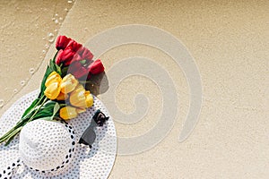 Tulips, yellow and red paste with white sun hat with black sunglasses