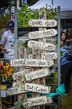 Tulsa USA Garden show with vintage Grandmas House signs for sale displayed beside flowers and plants