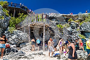 TULUM, MEXICO - FEB 29, 2016: Tourists at the beach under the ruins of the ancient Maya city Tulum, Mexi