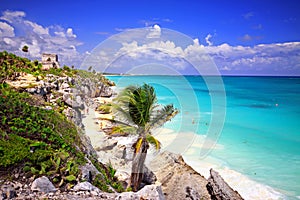 Tulum ruins over beach with palm