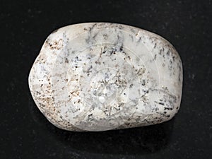 tumbled Albite gemstone on dark background