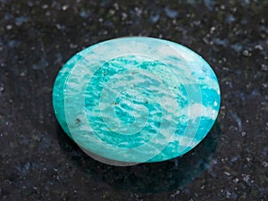 tumbled amazonite gemstone (amazon stone) on dark