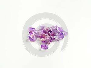 Tumbled Amethyst stones close up on table for crystal therapy tr