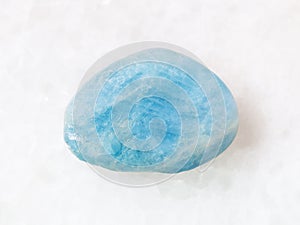 tumbled aquamarine (blue beryl) gem stone on white photo