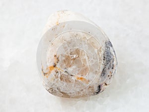 tumbled baryte stone on white marble