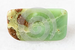 Tumbled Chrysoprase rock on white marble