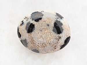 tumbled dalmatian stone on white marble