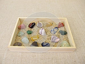 Tumbled gemstones in a wooden box