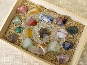 Tumbled gemstones in a wooden box