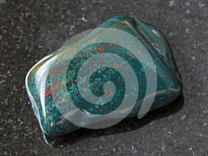tumbled green Heliotrope gem stone on dark