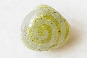 Tumbled Grossular green garnet rock on white