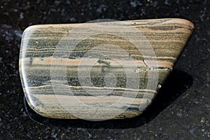 tumbled marl shale stone on dark background