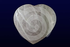 Tumbled and polished rose quartz heart on dark background