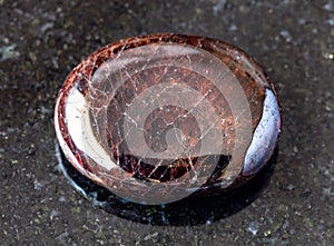 tumbled Pyrope garnet rock on black