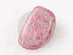 tumbled rhodonite gem on white