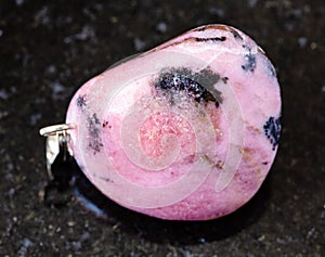 tumbled Rhodonite rock on black