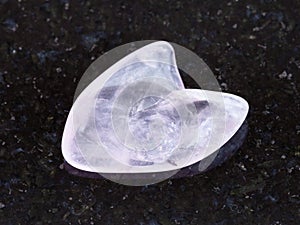 tumbled rose quartz stone in heart shape on dark
