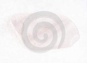 tumbled rose quartz stone on white