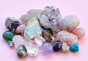 Tumbled and rough gemstones and crystals of various colors. Amethyst, rose quartz, agate, apatite, aventurine, olivine, turquoise
