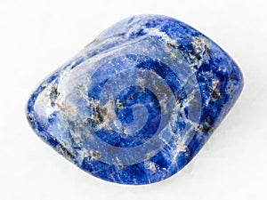 tumbled Sodalite gemstone on white marble